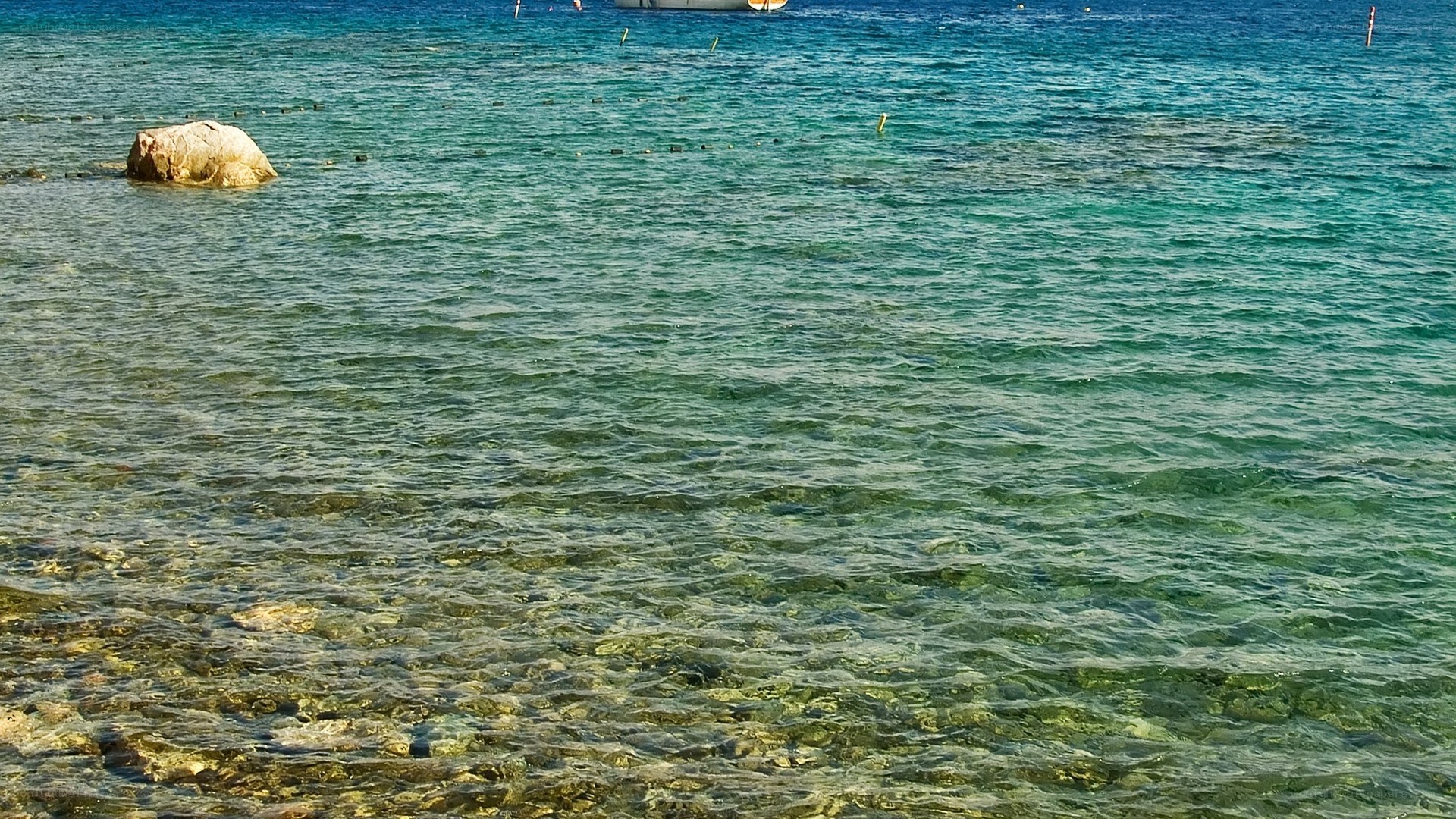 Clear turquoise water with rock