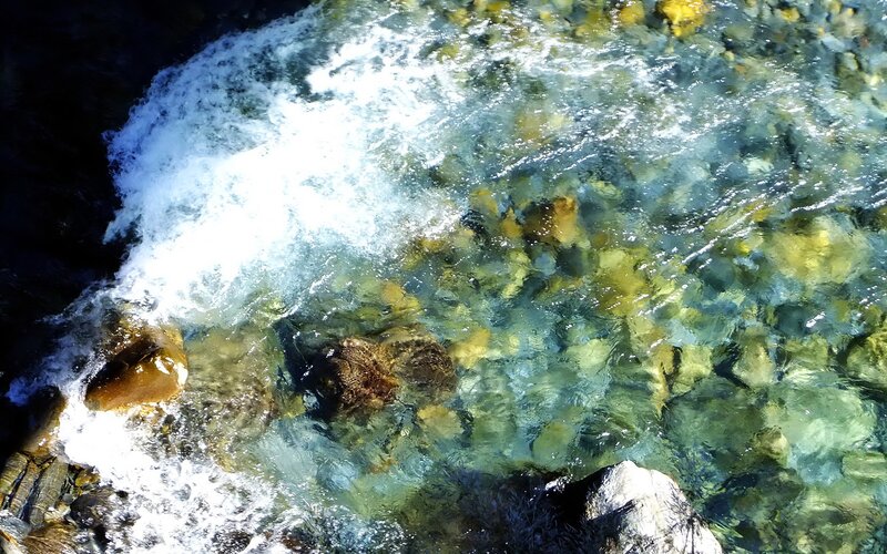 Clear Water Flowing over Rocks — Blue