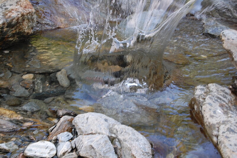 Clear Water Flowing over Rocks — Gray