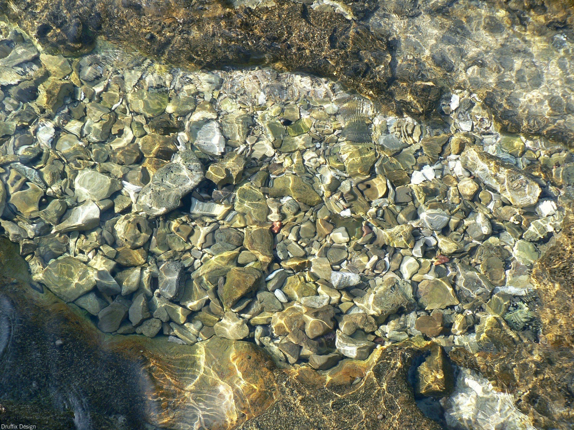 Clear water over pebbles