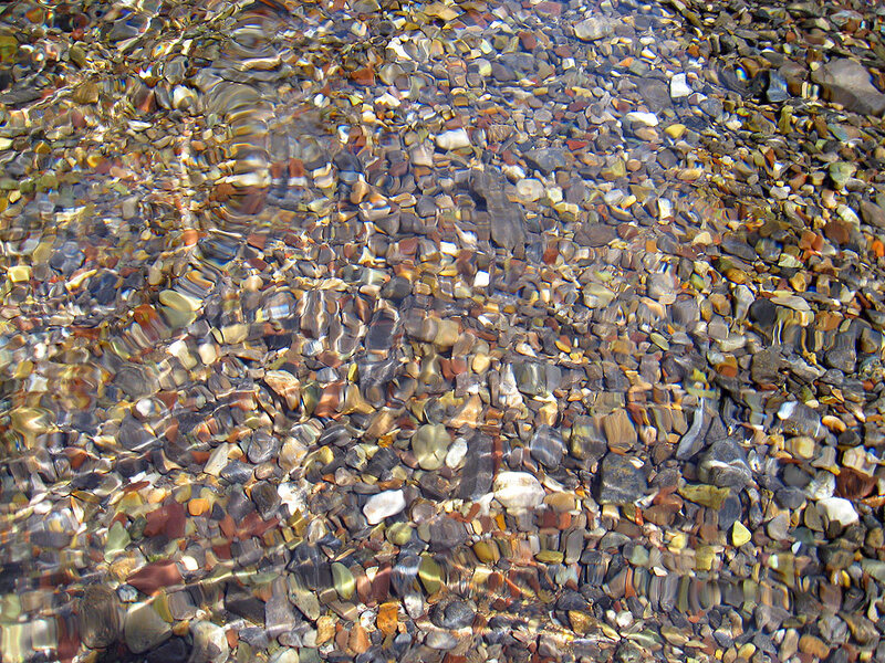 Clear water over pebbles