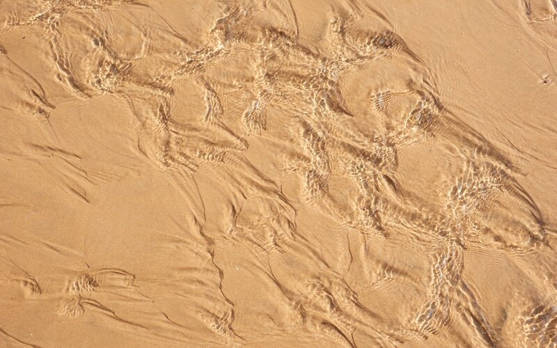 Clear water over sandy beach