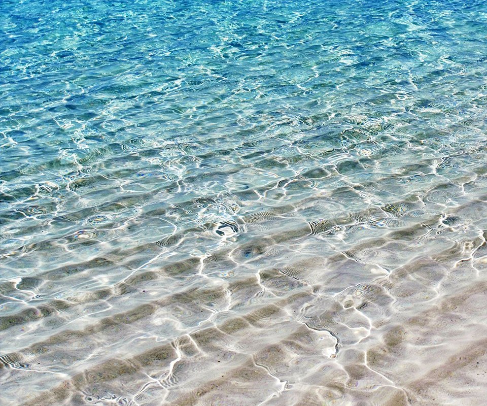 Clear water over sandy beach