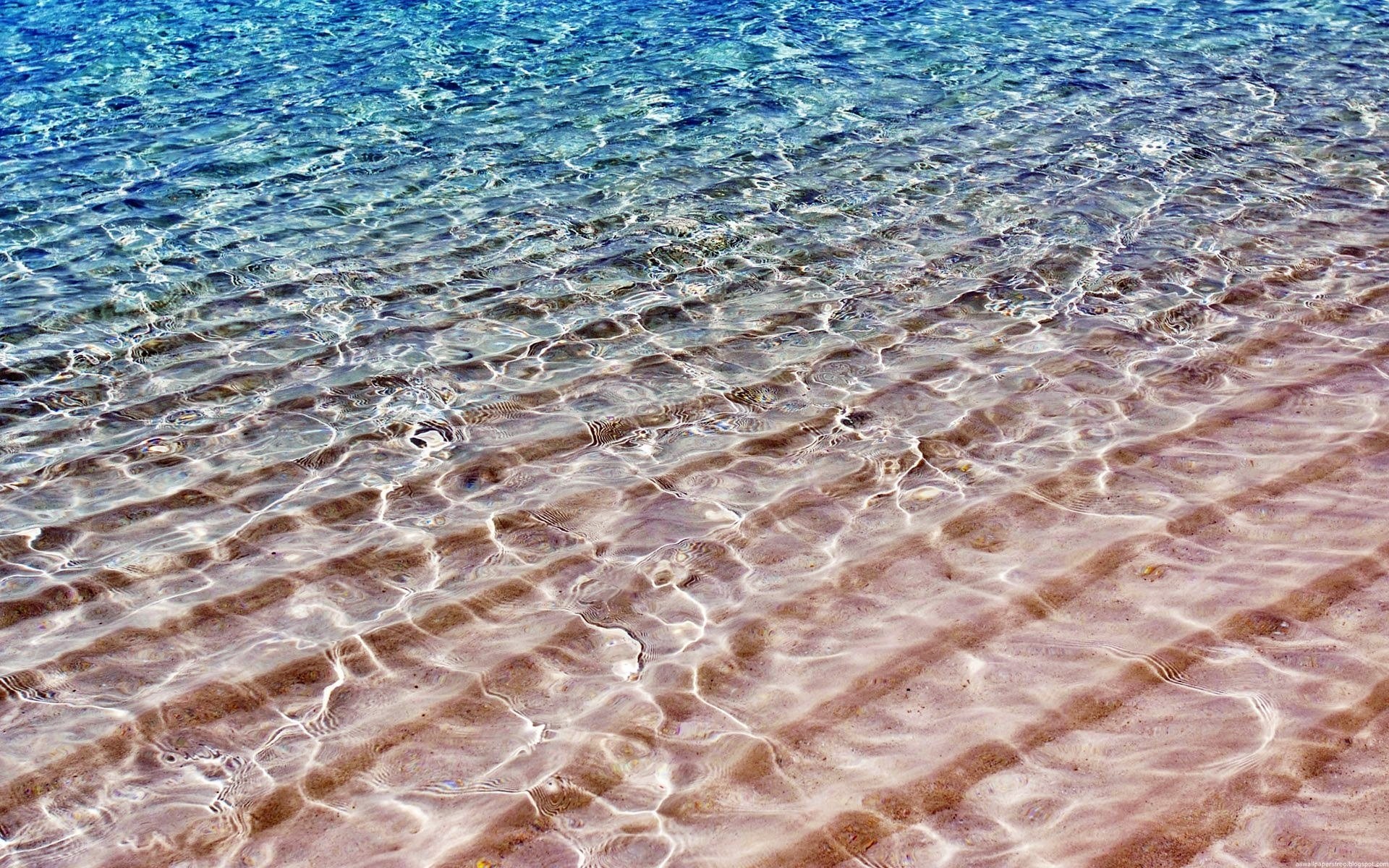 Clear water over sandy beach