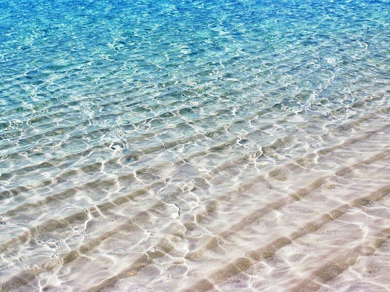 Clear water over sandy beach
