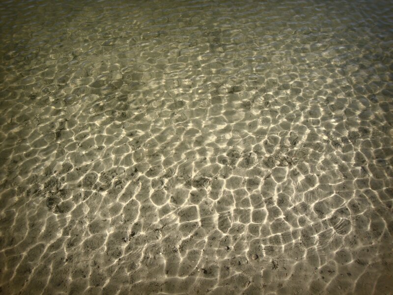 Clear water ripples on sandy bottom