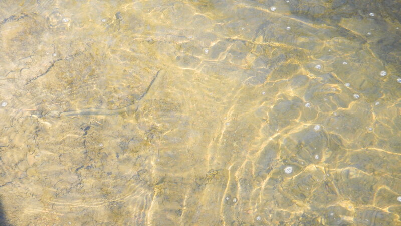 Clear water with underwater rocks