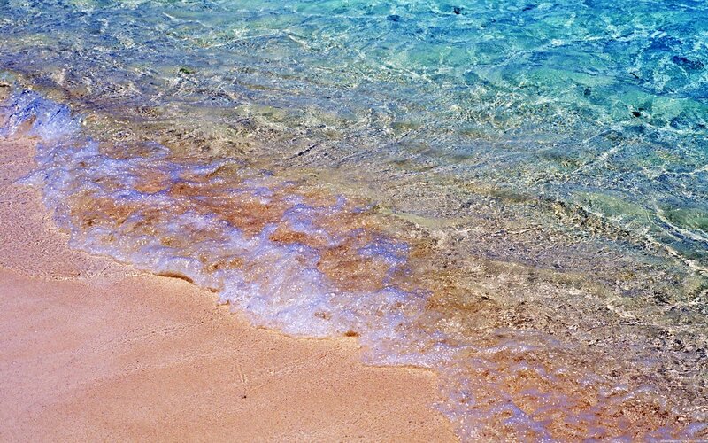 Clear waves on sandy beach