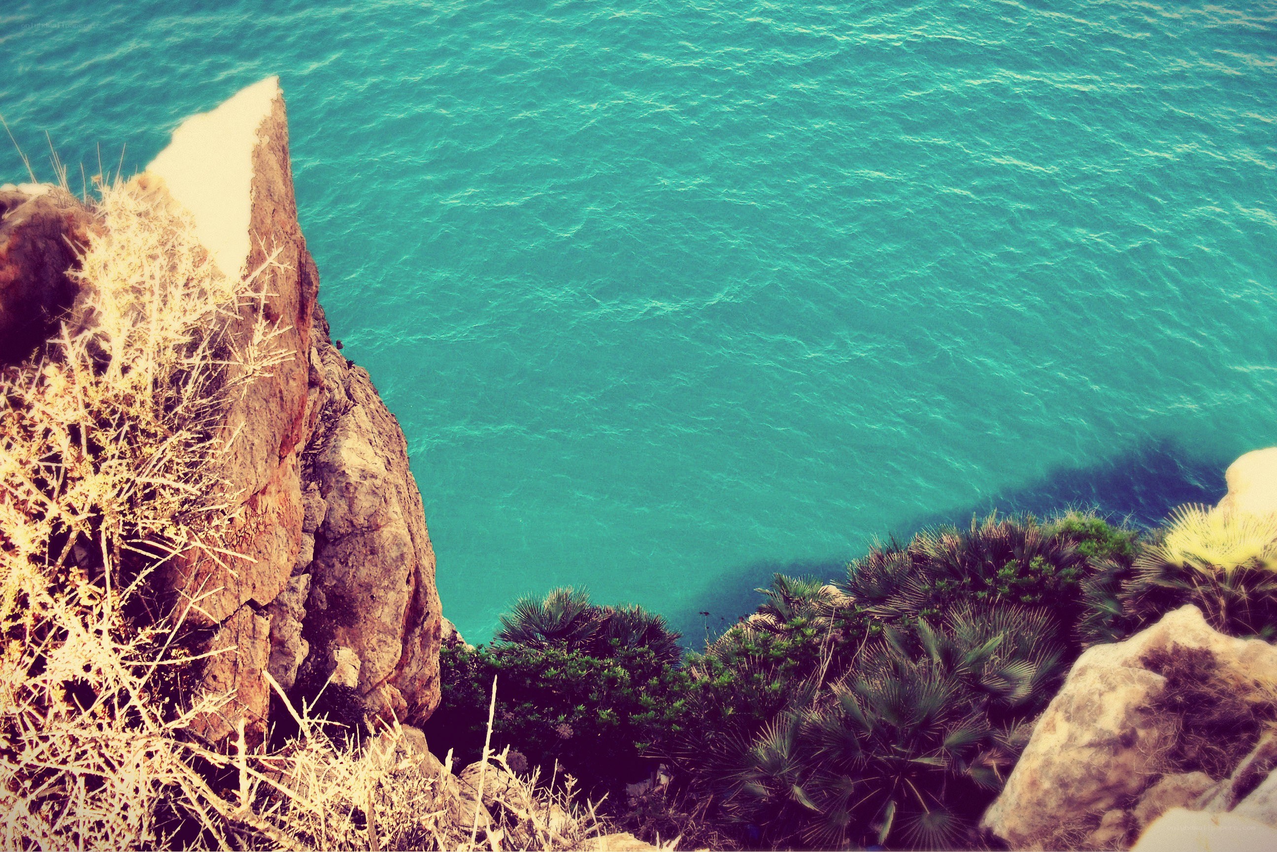 cliff overlooking turquoise sea