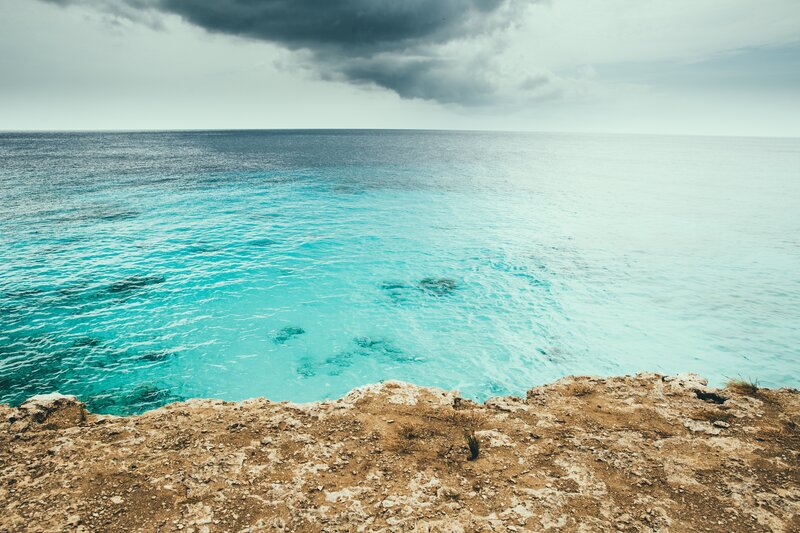 Cliff Overlooking Turquoise Sea — Blue