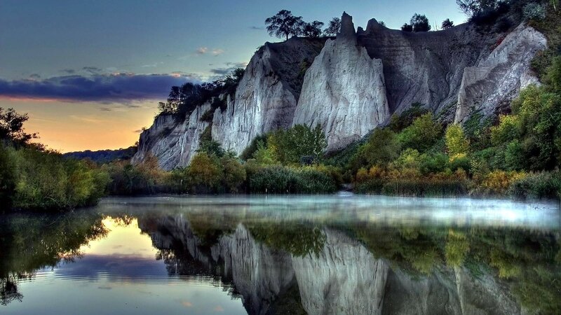 Cliff Reflected in Lake — Blue, Serene, Sunset