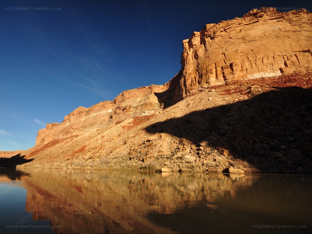 Cliff reflection in calm water