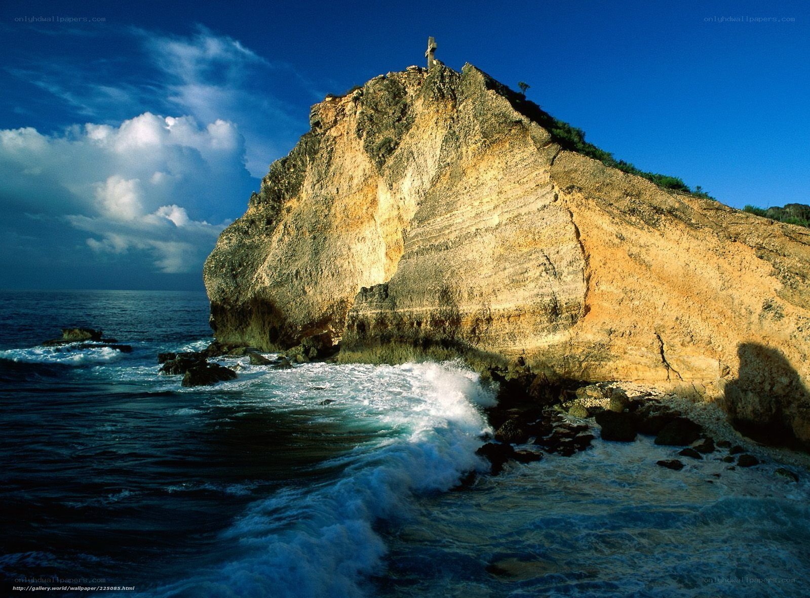 Cliff with cross by the sea