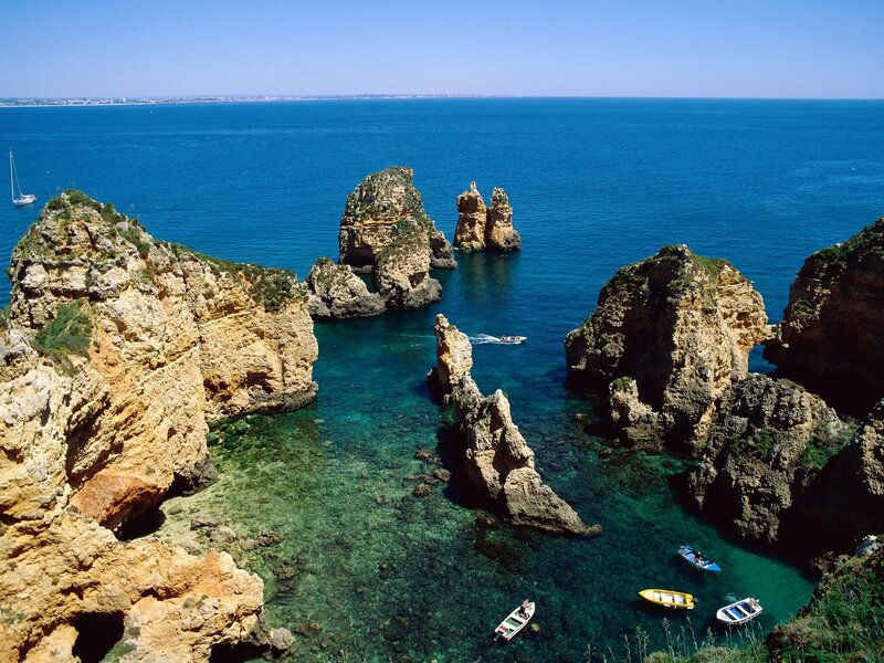 cliffs and boats in blue sea