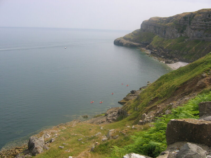 cliffs and kayakers by the sea