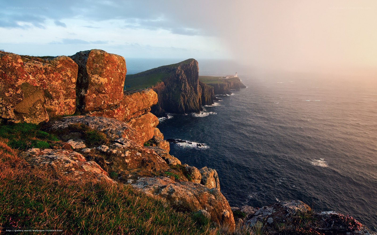 Cliffs and lighthouse at sunset