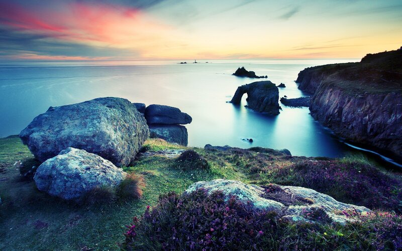 Cliffs and sea arch at sunset