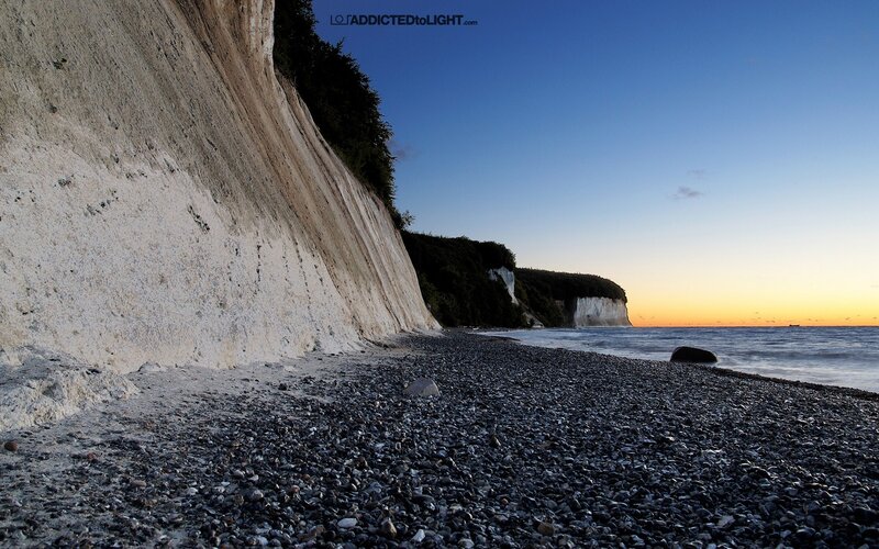 Cliffs at sunset on a pebble beach