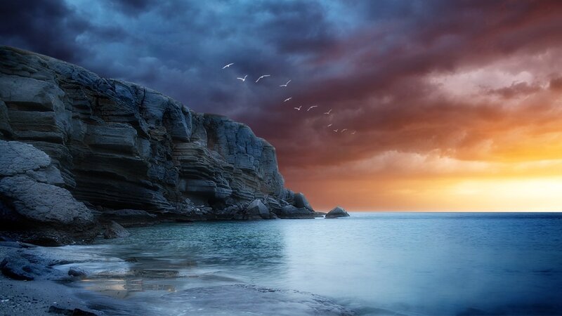 Cliffs at sunset with birds