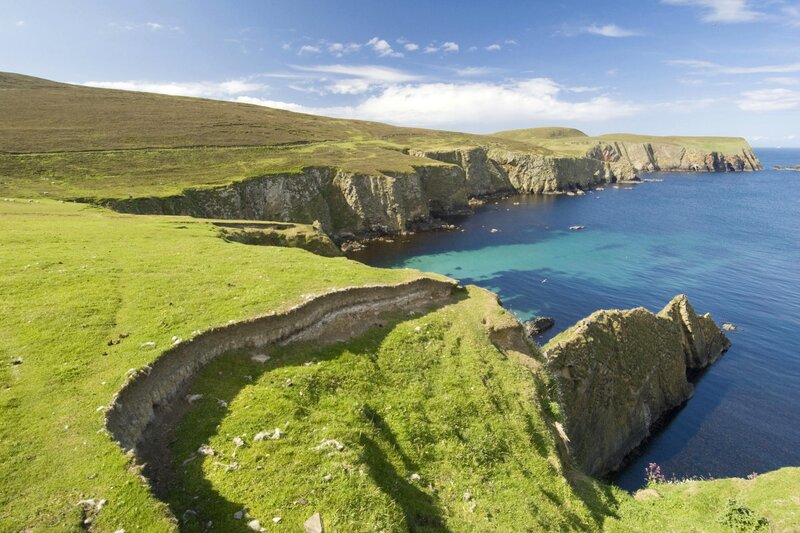 cliffs overlooking a turquoise bay