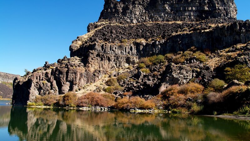 Cliffs reflected in calm river