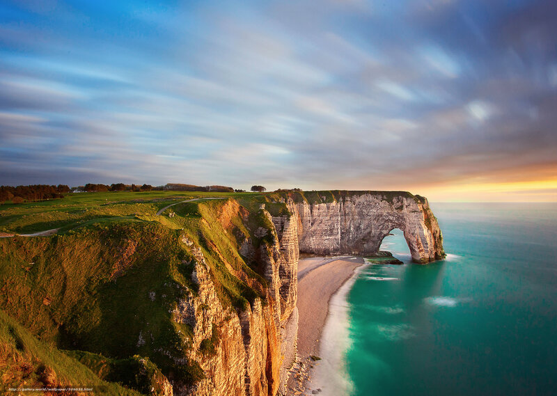 Cliffs with natural arch at sunset
