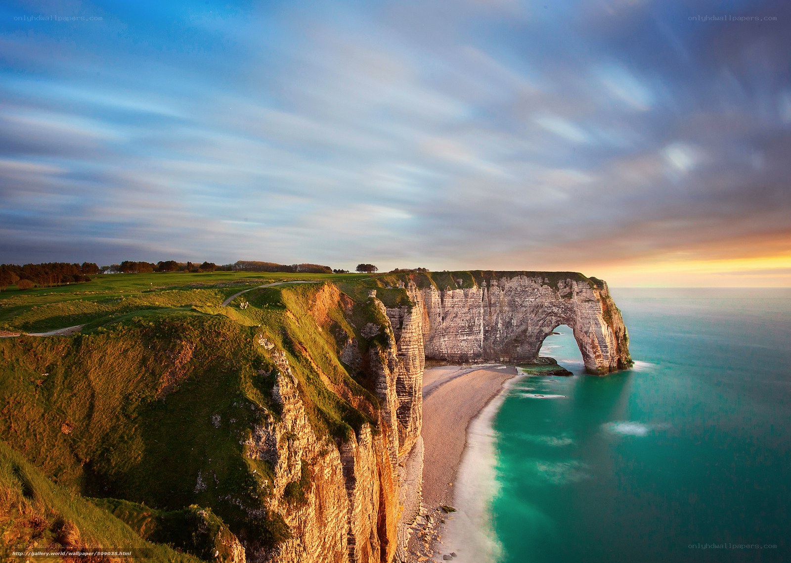 Cliffs with natural arch at sunset