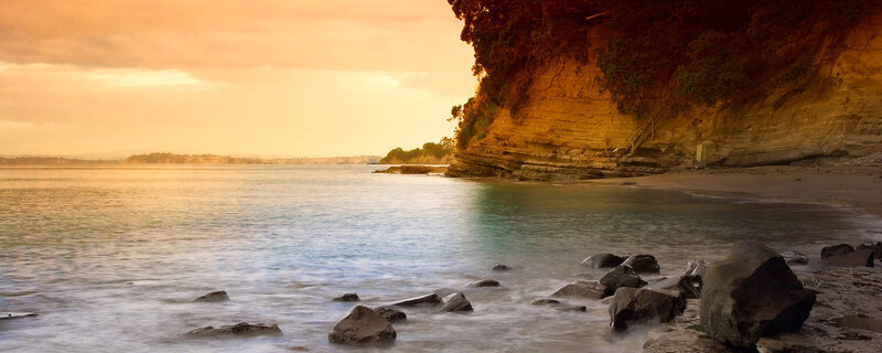 Cliffside Beach at Sunset — Orange, Serene, Photograph, Ocean, Rocks, Cliff