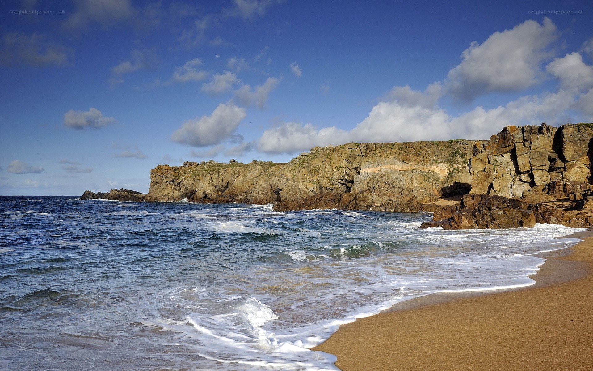 cliffside beach with crashing waves