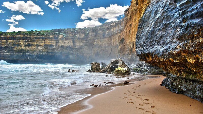 cliffside beach with footprints