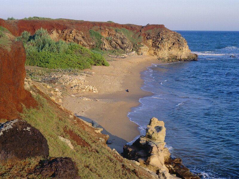 cliffside beach with red earth