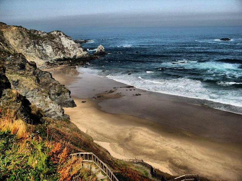 cliffside beach with wooden stairs