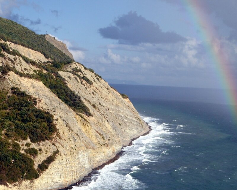 Cliffside coast with rainbow