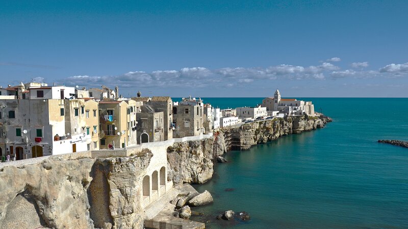 Cliffside Coastal Town — Blue, Serene, Afternoon, Photograph, Buildings