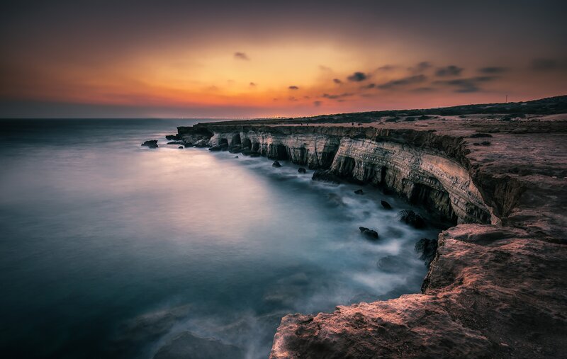 Cliffside Coastline at Dusk — Orange