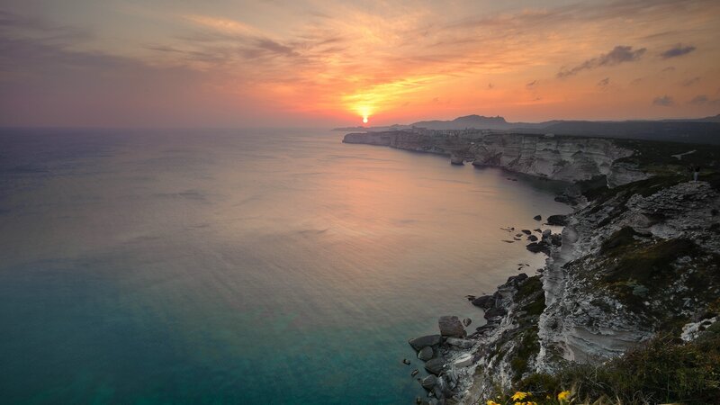 Cliffside Coastline at Sunset — Orange, Serene, Photograph, Sun, Ocean, Cliffs