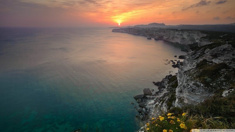 Cliffside Coastline at Sunset — Orange, Serene, Photograph