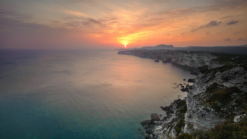 Cliffside Coastline at Sunset — Orange, Serene