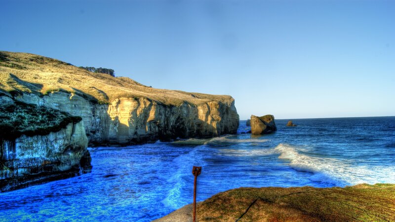 Cliffside Coastline — Blue, Dramatic, Afternoon, Photograph, Ocean, Rock Formations, Grass
