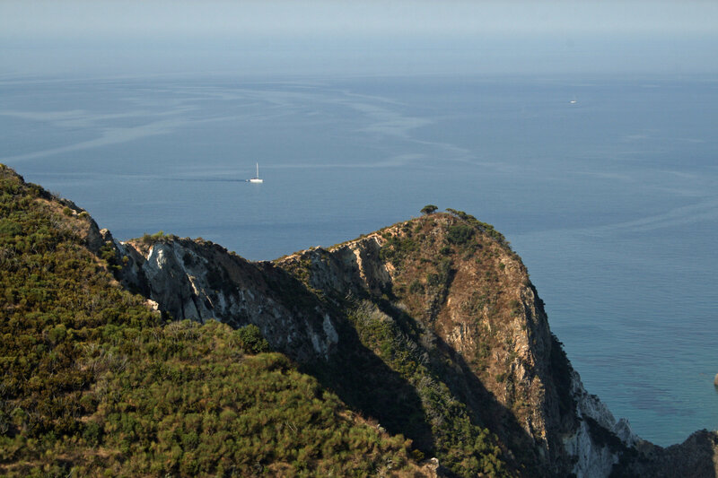 Cliffside Coastline — Blue, Serene, Afternoon, Photograph, Ocean, Sailboat