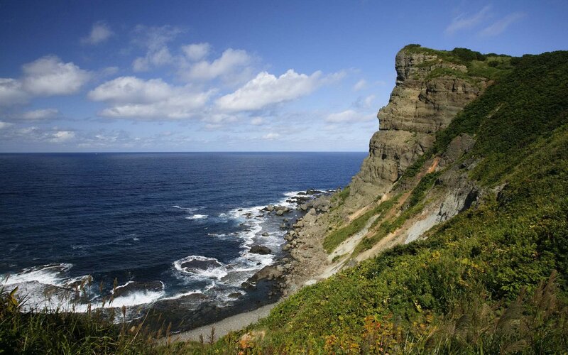 Cliffside Coastline — Blue, Serene, Afternoon, Photograph, Ocean, Sky, Rocks, Green, Gray