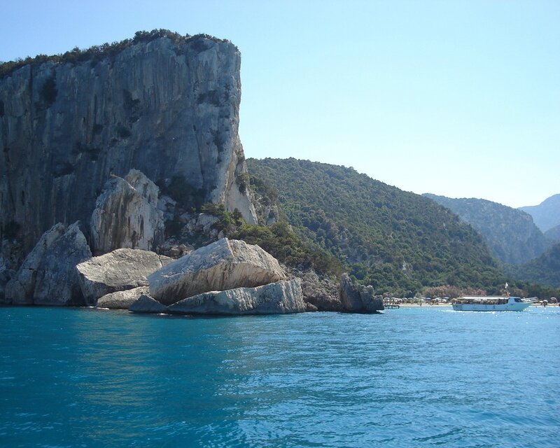 Cliffside Coastline — Blue, Serene, Afternoon, Photograph, Sea, Boat