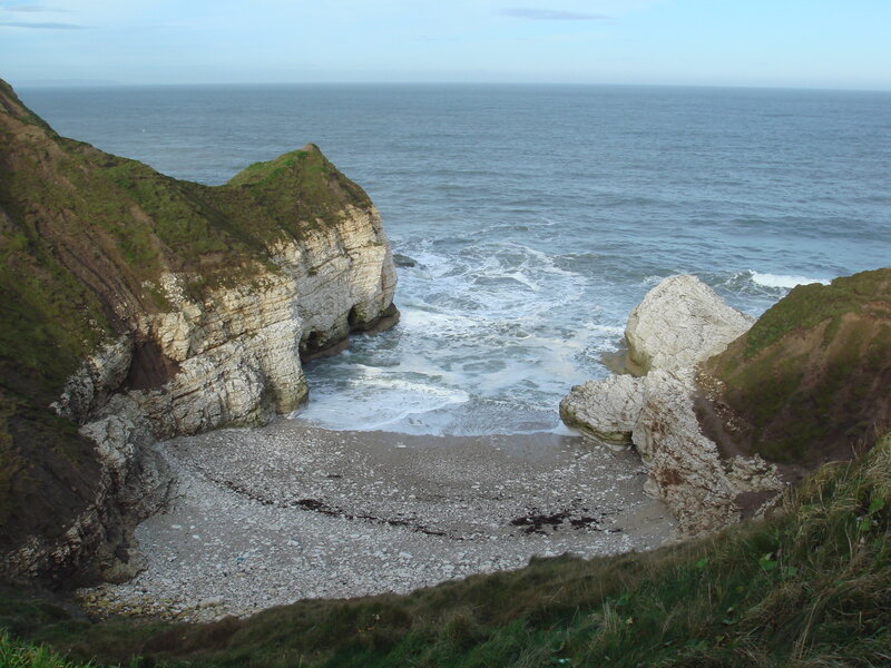 cliffside cove with pebble beach