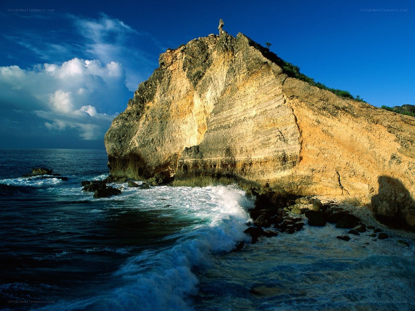 Cliffside cross by the sea