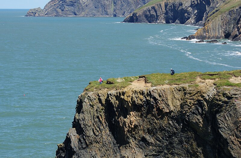 cliffside hikers by the sea