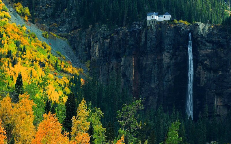 cliffside house with waterfall