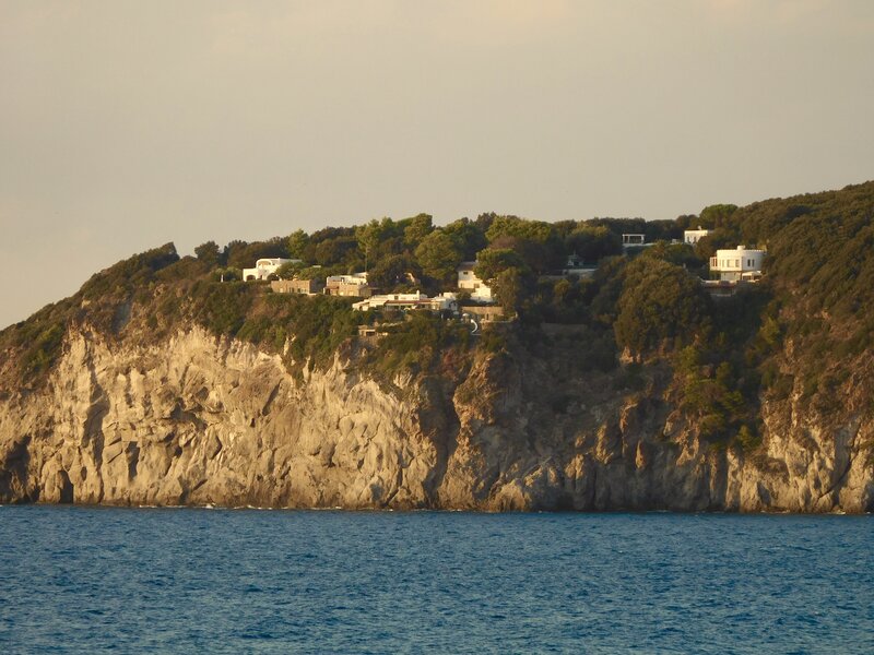 Cliffside Houses by Sea — Blue, Serene, Sunset