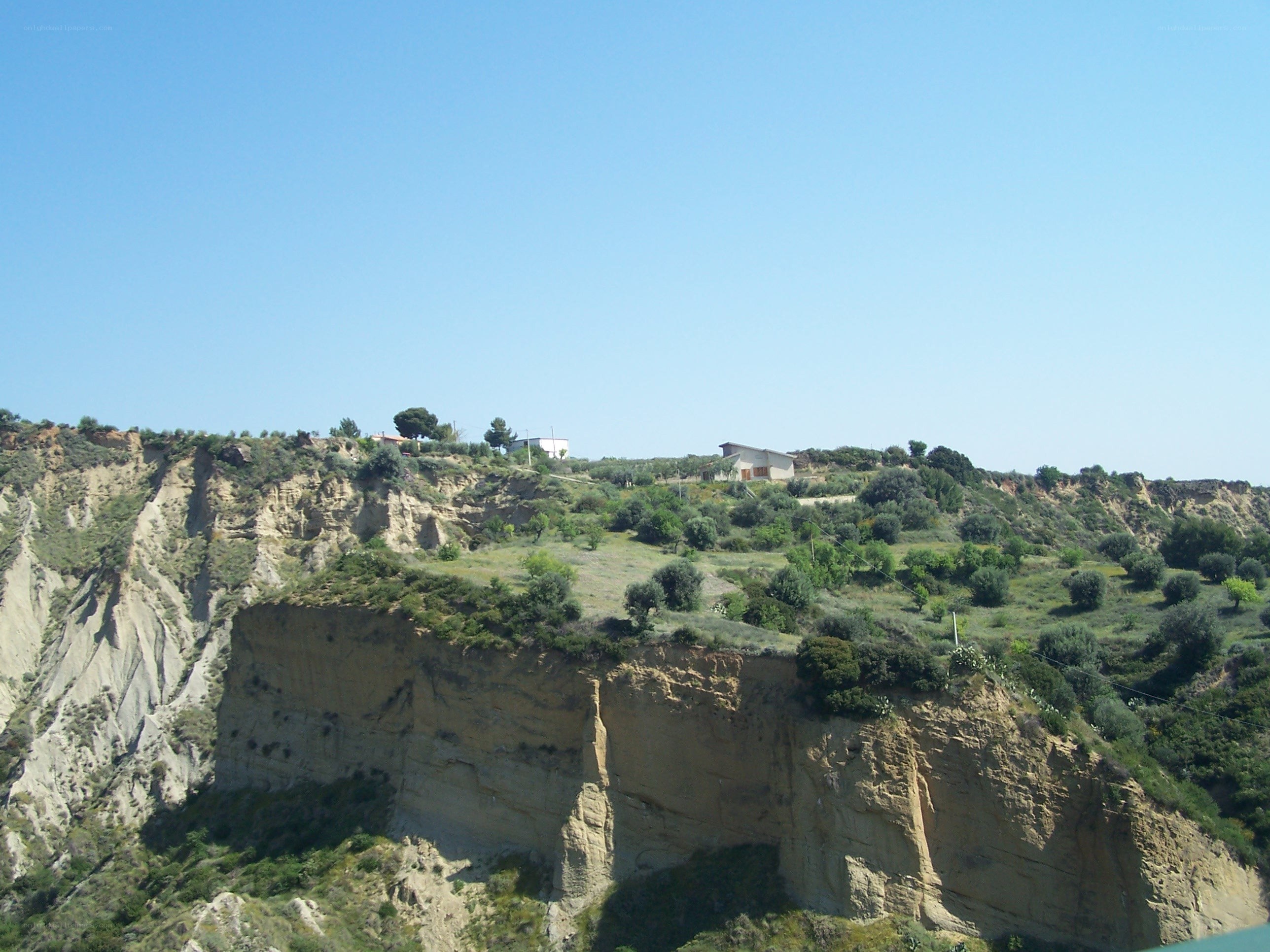 cliffside houses under blue sky