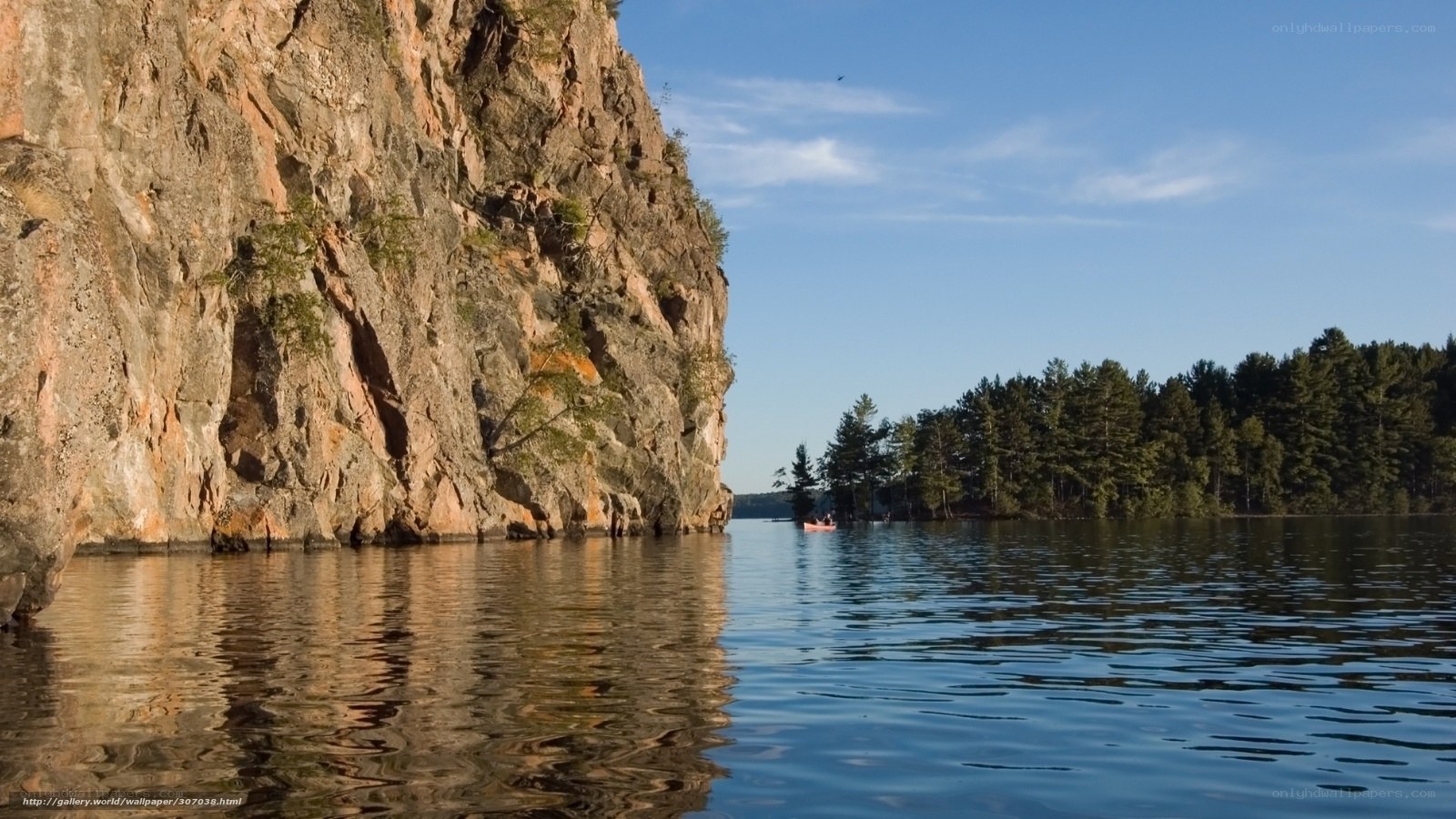 Cliffside lake with kayaker