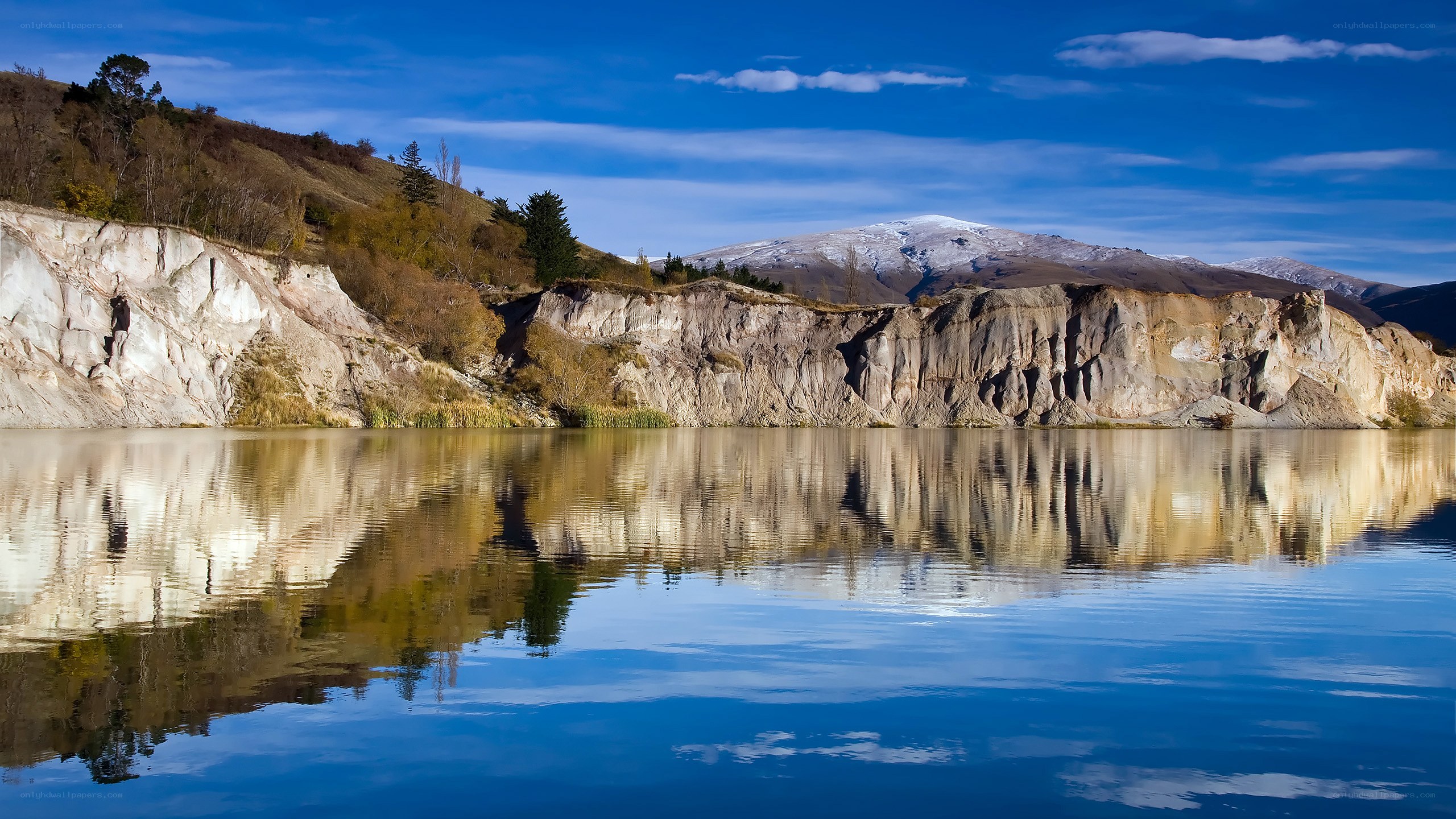 Cliffside lake with mountain reflection
